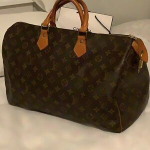 Louis Vuitton Brown Duffel Bag with Iconic Monogram and Leather Trim